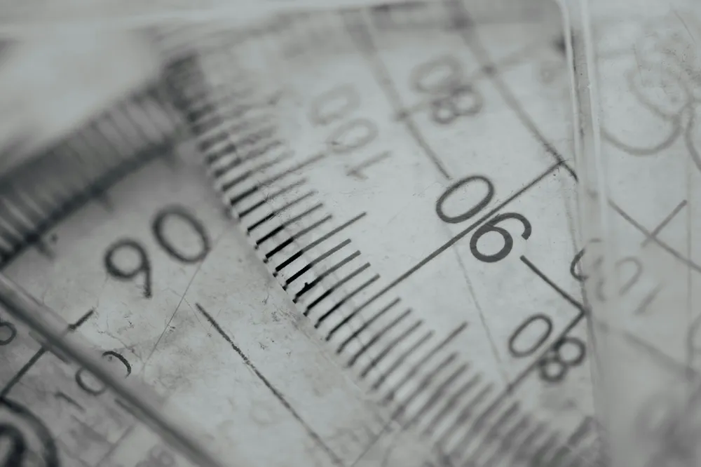 Close-up of transparent rulers and a protractor overlapping, their scale markings out of focus